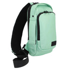 Mint green sling bag with black straps on a light gray background